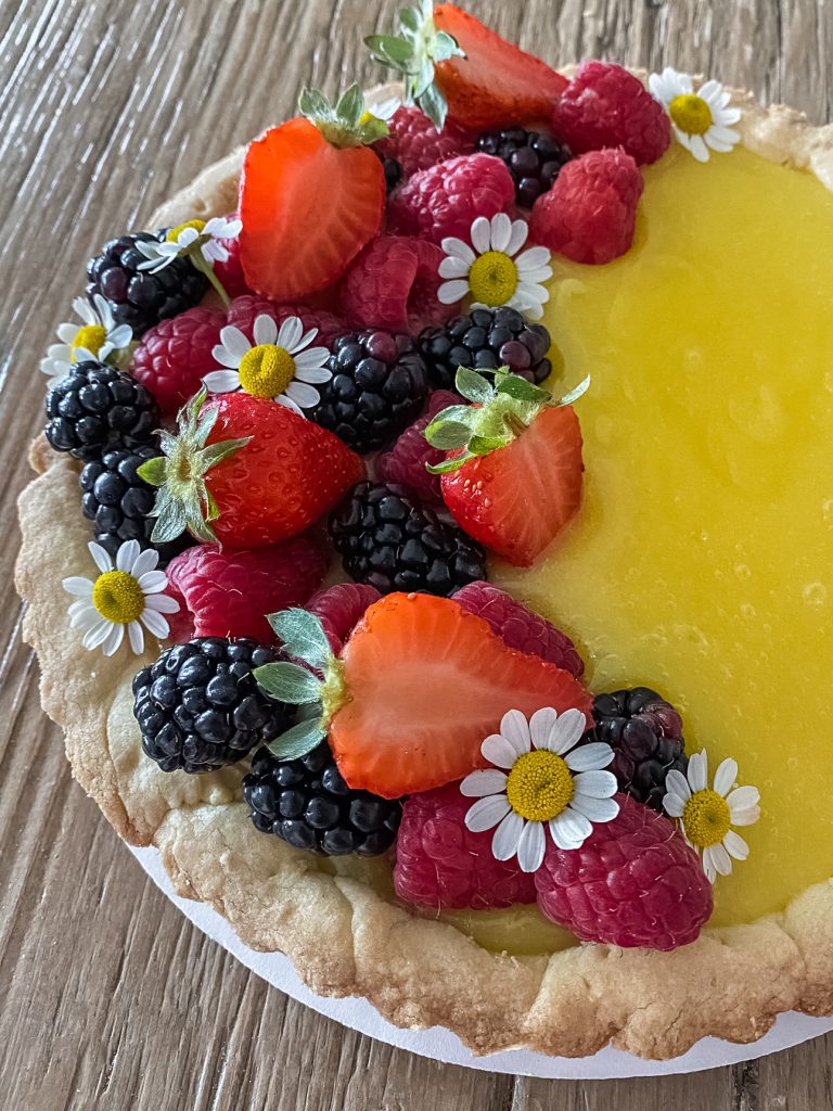 gluten free lemon tart topped with berries