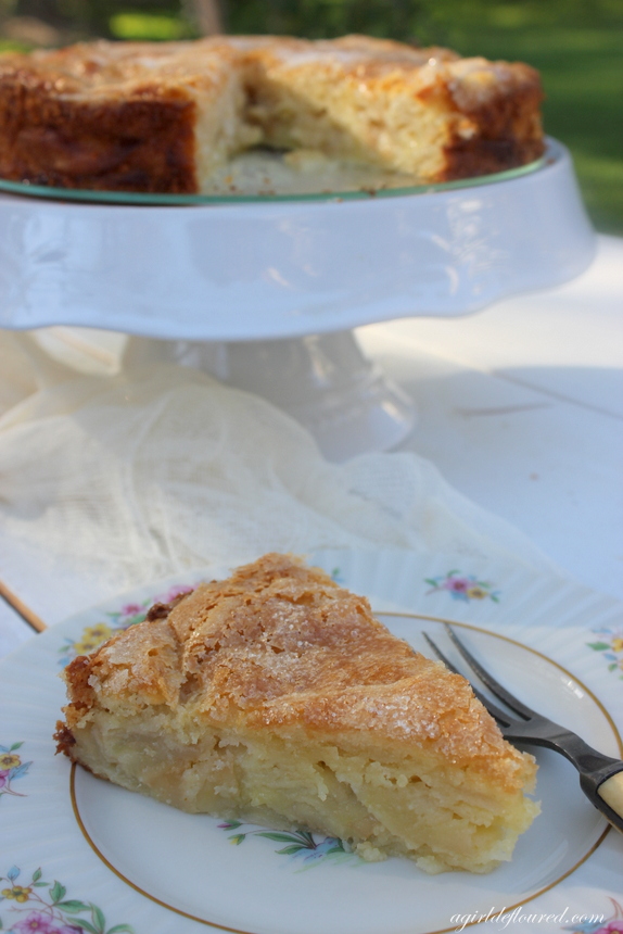 A slice of gluten free French Apple Cake on an antique plate