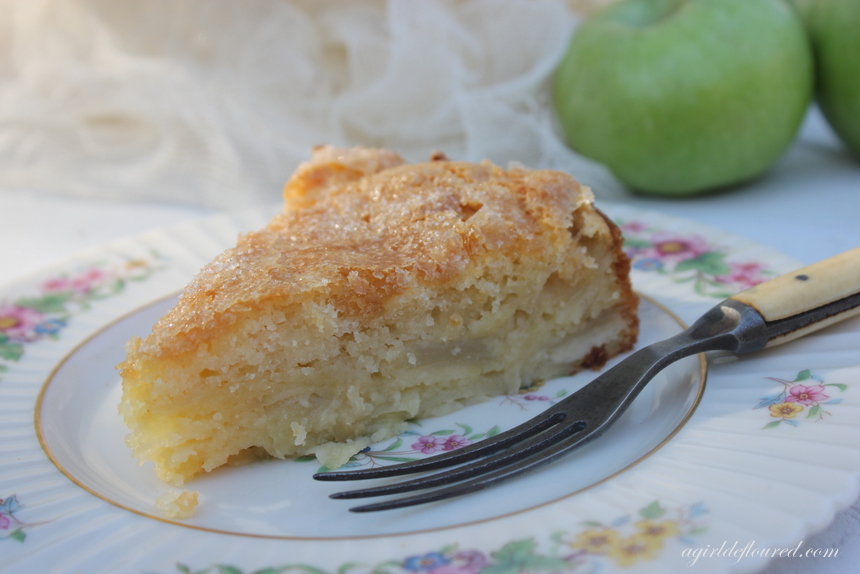 A slice of gluten free French Apple Cake on an antique plate