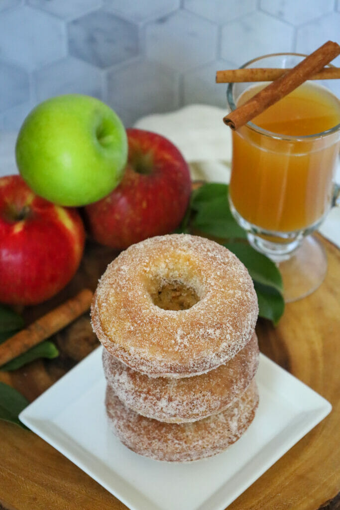 Baked Gluten Free Apple Cider Doughnuts with a mug of cider