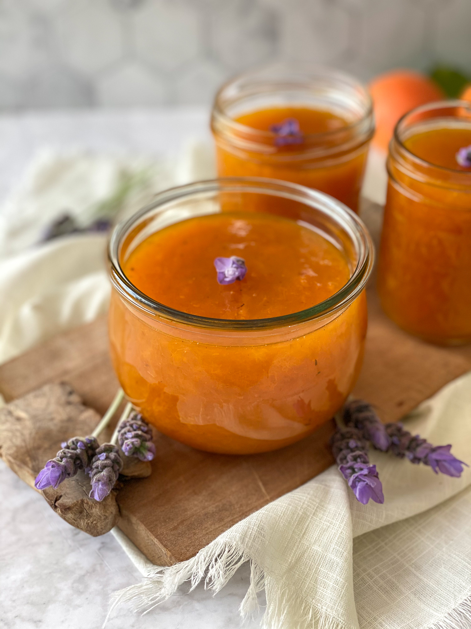 A Unique and Delicious Recipe for Apricot Jam flavored with a touch of lavender sugar and topped with fresh lavender blossoms