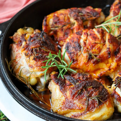 Oven Chicken Thigh Recipe with Paprika and Rosemary garnished with rosemary