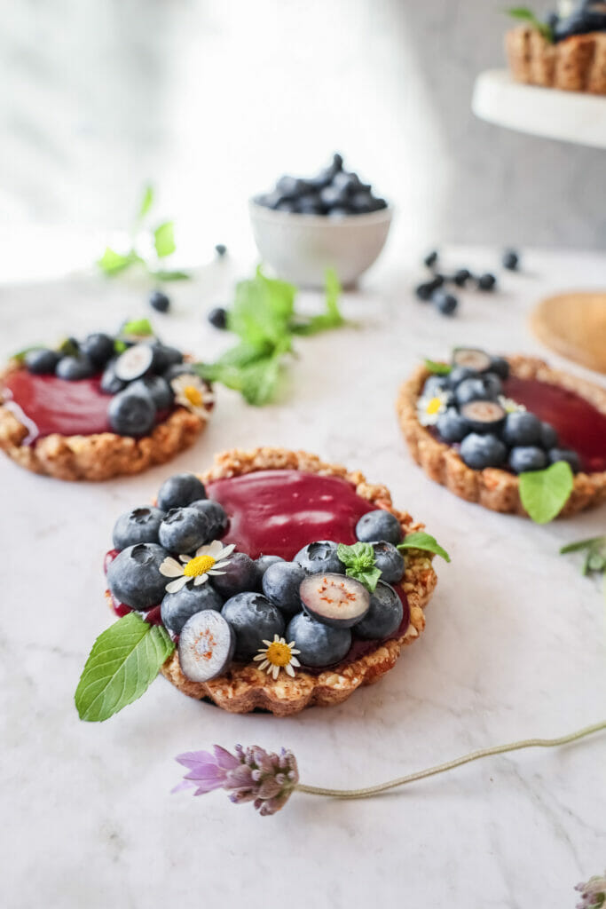 Blueberry Curd Tarts Gluten free Dessert Recipe decorated with berries and flowers