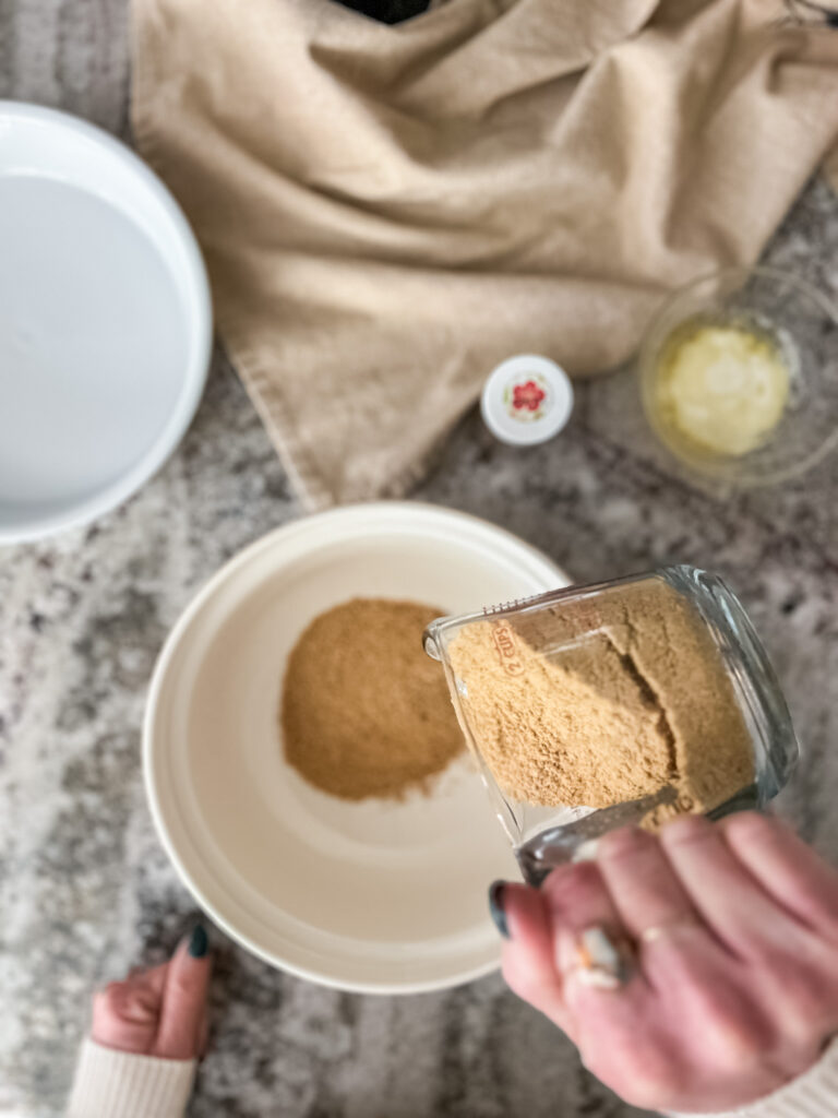 pouring graham crackers into bowl