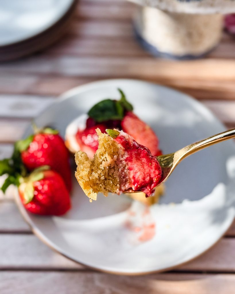 a forkful of buttermilk cake topped with roasted strawberries