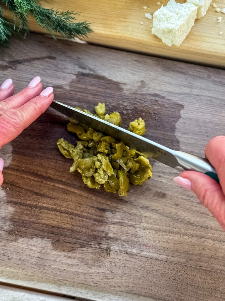chopping olives for dressing
