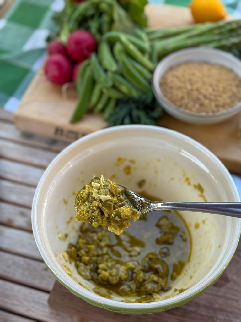 a spoonful of smashed olive dressing